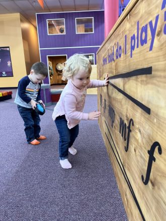 Girls showing off their homemade ukuleles
